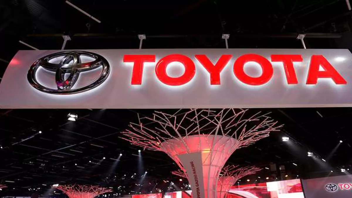 Toyota nine-month net profit dives 30%, cuts forecast 