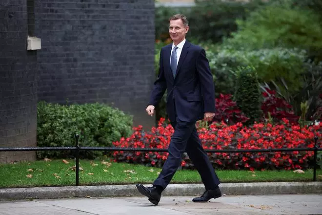 Jeremy Hunt walks outside Downing Street in London.