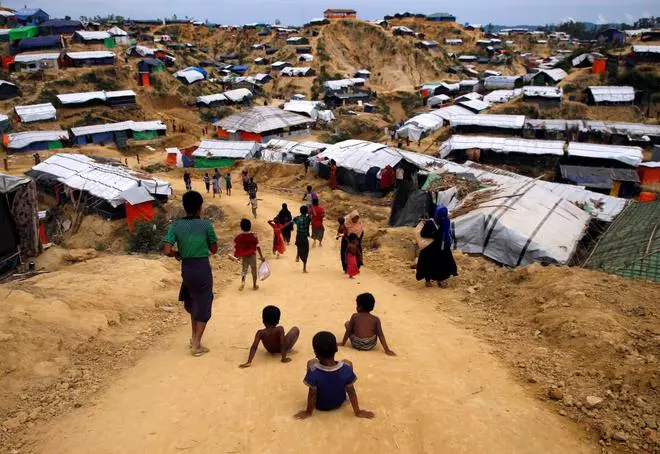 Rohingya refugee children slide down the road at Balu Khali refugee camp near Cox’s Bazar, Bangladesh November 16, 2017. 